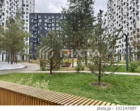 Stylish modern residential complex with playgrounds and landscape in summer Stylish modern residential complex with playgrounds and landscape in summer 131147897