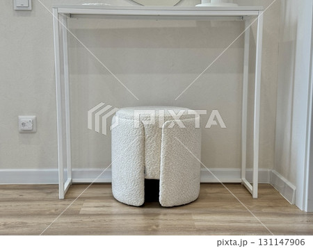 a white ottoman for sitting in a modern and stylish interior a white ottoman for sitting in a modern and stylish interior 131147906