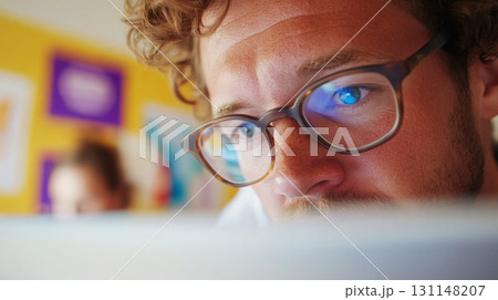 HR manager observes as a young man fills out a digital feedback survey on a laptop in a spacious office with natural wood textures. Survey research answer checklist 131148207