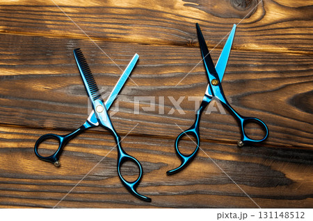 Professional hairdressing scissors and thinning shears on wood Professional hairdressing scissors and thinning shears on wood 131148512