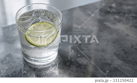 A glass of water with a lime slice in it 131150422