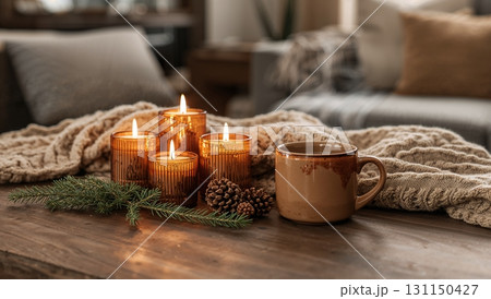A table with candles and a mug of coffee 131150427