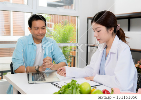 Asian nutritionist consulting patient in clinic, meal plan discussion, healthcare advice. Asian nutritionist consulting patient in clinic, meal plan discussion, healthcare advice. 131151050