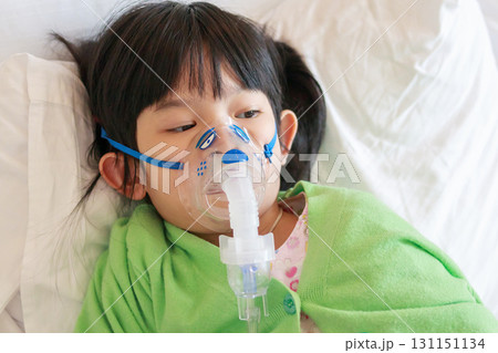 Sick little asian girl inhalation with nebulizer for respiratory treatment Sick little asian girl inhalation with nebulizer for respiratory treatment 131151134