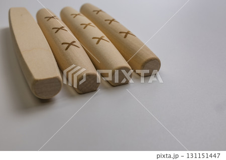 The Yut pieces from the traditional Korean game Yut Nori are neatly arranged on a white background. Close-up. The Yut pieces from the traditional Korean game Yut Nori are neatly arranged on a white background. Close-up. 131151447