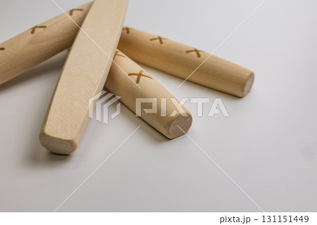 Yut pieces from the traditional Korean game Yut Nori are placed on a white background. Close-up. 131151449