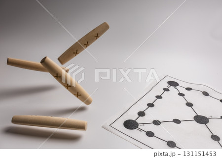 A close-up of a Yut board, a traditional Korean game, being thrown and falling. 131151453