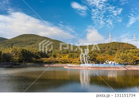 Lake and autumn mountains against the backdrop of Jangsan Mountain in Busan, South Korea. Wide-angle lens. Horizontal background. Clear clouds. 131151734