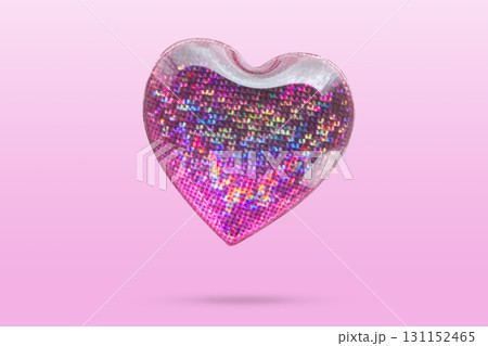 Pink heart shape hologram sticker flying on pink background 131152465