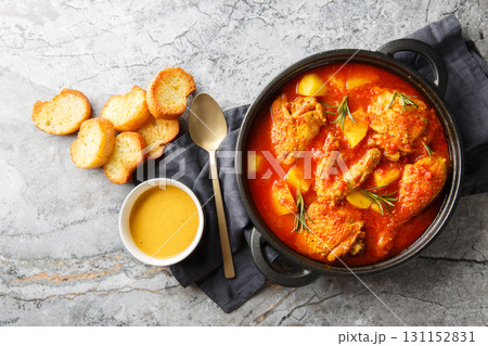 Chicken Bouillabaisse cooked in a delicious rich and fragrant broth closeup in the saucepan. Horizontal top view Chicken Bouillabaisse cooked in a delicious rich and fragrant broth closeup in the saucepan. Horizontal top view 131152831