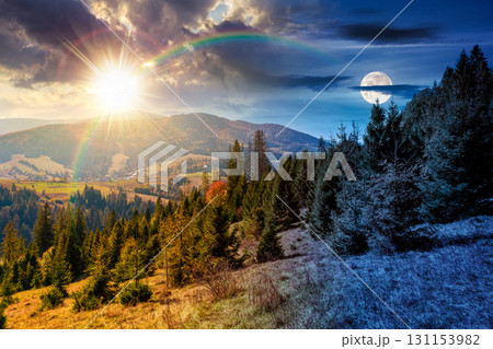 landscape with coniferous forest behind the meadow on autumn equinox. day and night time change concept. nature background with blue sky and mountain ridge with sun and moon. alpine woodland 131153982