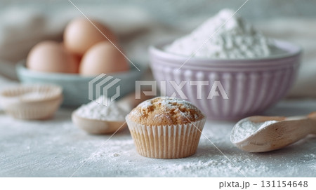 Delicious tiny cupcakes scattered alongside baking mix and eggs in a cozy kitchen setting 131154648