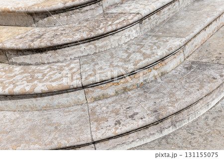 Close-up view of worn marble stairs with curved edges, showing natural textures Close-up view of worn marble stairs with curved edges, showing natural textures 131155075