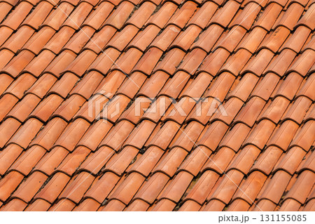 Macro view of orange red terracotta tiles laid in tight, overlapping rows Macro view of orange red terracotta tiles laid in tight, overlapping rows 131155085