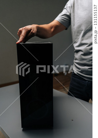 Technician finger indicating dust buildup on computer case surface, highlighting critical need for systematic electronic device cleaning and preservation. Concept of service, repair, cleaning computer 131155137