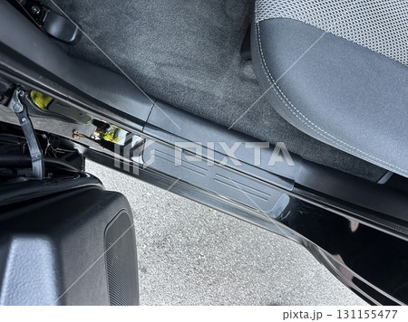 Close view of a sleek car interior showing detailed features of the door frame and seat area, capturing the elegance of modern automotive design under bright daylight 131155477
