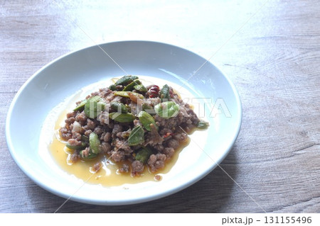 spicy fried chop pork with flat bean in shrimp paste curry Thai southern food on plate   131155496