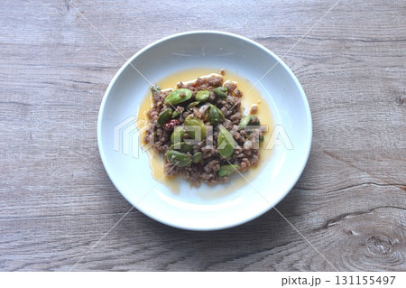 spicy fried chop pork with flat bean in shrimp paste curry Thai southern food on plate spicy fried chop pork with flat bean in shrimp paste curry Thai southern food on plate 131155497