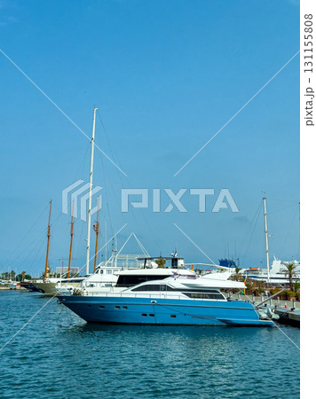 Luxury yacht docked in a marina surrounded by boats and clear blue skies on a sunny day Luxury yacht docked in a marina surrounded by boats and clear blue skies on a sunny day 131155808
