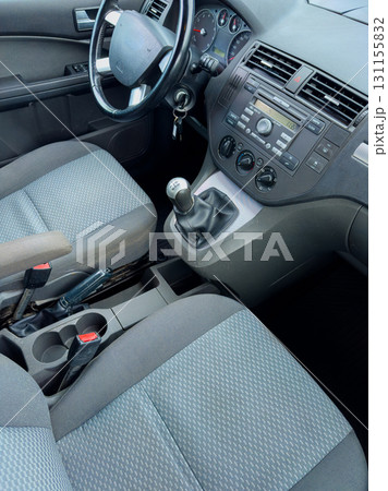 Interior view of a modern vehicle showcasing seats, gear shift, and dashboard in a contemporary design setting 131155832