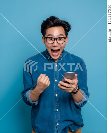 young man excited after checking profit on smartphone 131157510