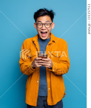 young man excited after checking profit on smartphone 131157511