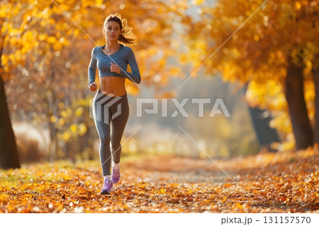 woman jogging in park autumn leaves healthy lifestyle 131157570