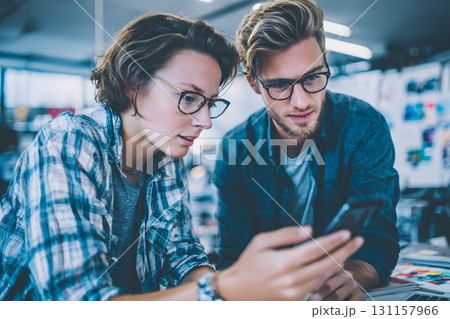 entrepreneurs developing mobile app prototype together 131157966