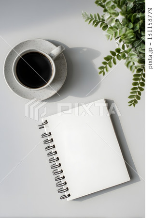 clean flat lay of notebook on plain desk with copy space 131158779