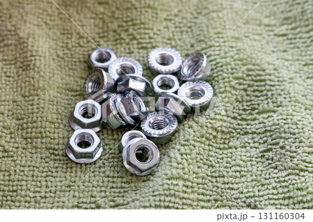 locknut hex pile on green background for threaded connection 131160304