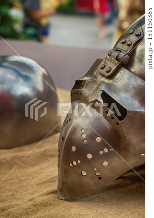 iron helmet with a folding visor close-up, part of the ammunition of a medieval warrior iron helmet with a folding visor close-up, part of the ammunition of a medieval warrior 131160365