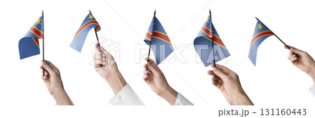 The Democratic Republic of the Congo flag in hand in different angles on a white background 131160443