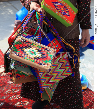 Handmade decorative bags and carpets with traditional ornament. Turkmenistan. Ashkhabad market. Handmade decorative bags and carpets with traditional ornament. Turkmenistan. Ashkhabad market. 131162150