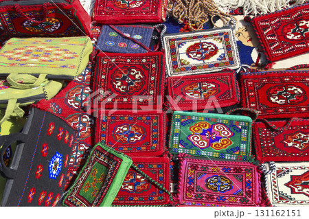 Handmade decorative bags and carpets with traditional ornament. Turkmenistan. Ashkhabad market. Handmade decorative bags and carpets with traditional ornament. Turkmenistan. Ashkhabad market. 131162151