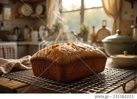 Steaming Hot Homemade Bread Cooling on a Rack 131162223