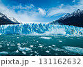 The majestic glacier with ice breaking into the blue lake and water splashing. The blue lake has many iceberg floating. 131162632
