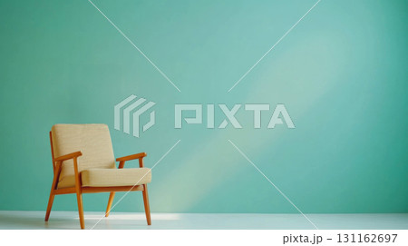 Mid century chair against teal wall, creating serene atmosphere 131162697