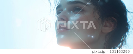 Young woman with glowing skin gazes upward in soft light Young woman with glowing skin gazes upward in soft light 131163299