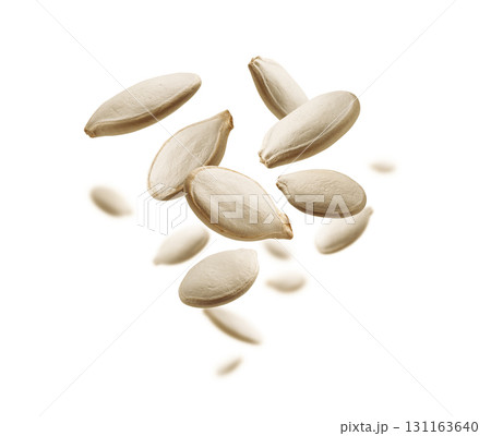 Pumpkin seeds levitate on a white background 131163640