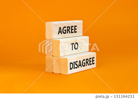 Agree to disagree symbol. Concept words Agree to disagree on beautiful wooden block. Beautiful orange table orange background. Business and agree to disagree concept. Copy space. 131164231