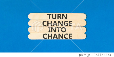 Turn change into chance symbol. Concept words phrase Turn change into chance on beautiful wooden stick. Beautiful blue paper background. Business Turn change into chance concept. Copy space. 131164273
