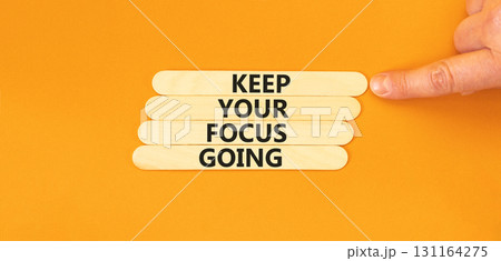 Keep your focus going symbol. Concept words Keep your focus going on beautiful wooden sticks. Beautiful orange table orange background. Business and keep your focus going concept. Copy space. Keep your focus going symbol. Concept words Keep your focus going on beautiful wooden sticks. Beautiful orange table orange background. Business and keep your focus going concept. Copy space. 131164275