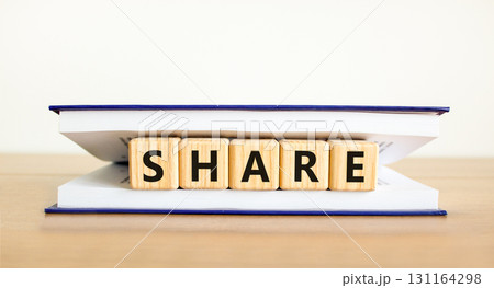 Share symbol. Concept word Share on beautiful wooden blocks in book. Beautiful wooden table white background. Business lifestyle share concept. Copy space. 131164298