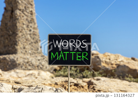 Words matter symbol. Concept word Words matter on beautiful black blackboard. Beautiful stone and blue sky background. Black blackboard. Business words matter concept. Copy space. 131164327