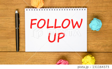 Follow up symbol. Concept word Follow up on beautiful white note. Black pen, colored paper. Beautiful wooden background. Business follow up concept. Copy space. Follow up symbol. Concept word Follow up on beautiful white note. Black pen, colored paper. Beautiful wooden background. Business follow up concept. Copy space. 131164373