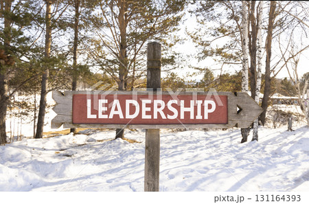 Leadership symbol. Concept word Leadership on beautiful wooden road sign. Beautiful winter forest background. Business leadership concept. Copy space. Leadership symbol. Concept word Leadership on beautiful wooden road sign. Beautiful winter forest background. Business leadership concept. Copy space. 131164393
