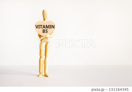 Vitamin B5 pantothenic acid symbol. Concept words Vitamin B5 on beautiful wooden heart. Doctor's model. Beautiful white background. Copy space. Medical healthy lifestyle Vitamin B5 concept. Vitamin B5 pantothenic acid symbol. Concept words Vitamin B5 on beautiful wooden heart. Doctor's model. Beautiful white background. Copy space. Medical healthy lifestyle Vitamin B5 concept. 131164395