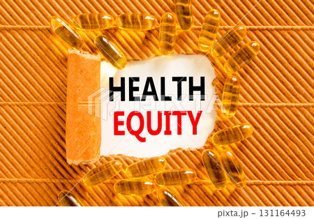 Health equity symbol. Concept words Health equity on beautiful white paper. Yellow pills tablets. Beautiful brown background. Medical healthy lifestyle health equity concept. Health equity symbol. Concept words Health equity on beautiful white paper. Yellow pills tablets. Beautiful brown background. Medical healthy lifestyle health equity concept. 131164493