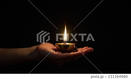 Minimalist Brass Diya Lighting Against Pure Black Background Symbolis. Dashahra, India. Minimalist Brass Diya Lighting Against Pure Black Background Symbolis. Dashahra, India. 131164980