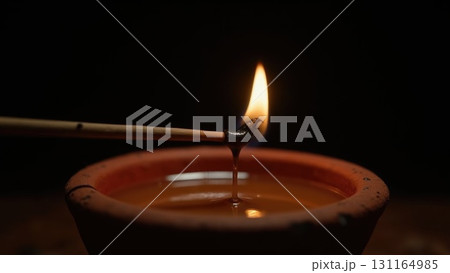 Macro Shot of Spark Igniting Wick on Diya Oil Lamp Moment of Light. Dashahra, India. 131164985